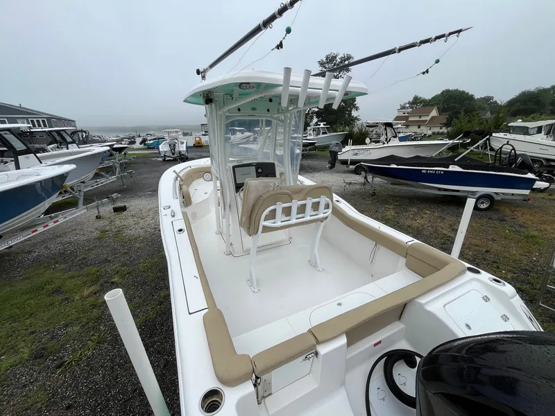 Slide: The Image of 2017 Tidewater 230 LXF boat with center console, parked in a marina. - 18