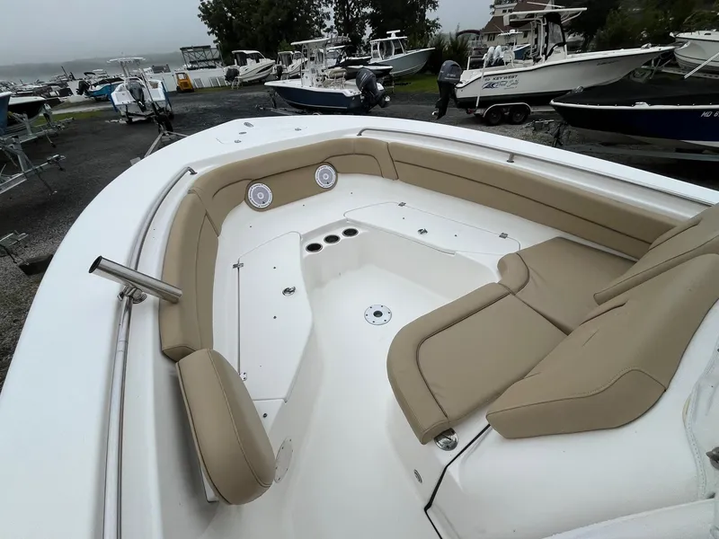 Slide: The Image of 2017 Tidewater 230 LXF boat with beige seating, docked among other boats. - 20
