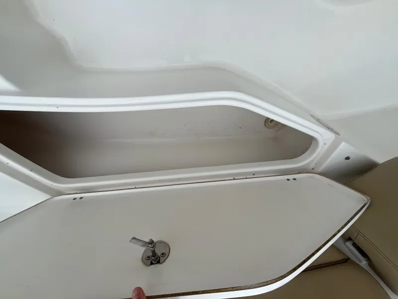 Slide: The Image of Storage compartment on a 2017 Tidewater 230 LXF boat, open with visible latch. - 21
