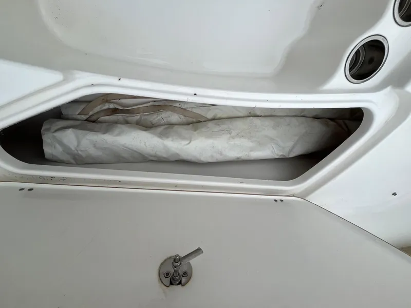 Slide: The Image of Storage compartment of a 2017 Tidewater 230 LXF boat with rolled-up canvas. - 22