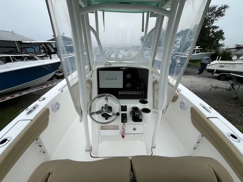 Slide: The Image of 2017 Tidewater 230 LXF boat cockpit with Garmin navigation system and beige seating. - 24