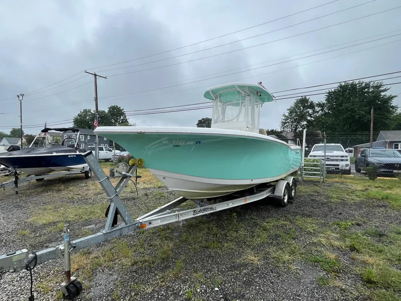 Slide: The Image of 2017 Tidewater 230 LXF boat on trailer, parked outdoors on a cloudy day. - 3