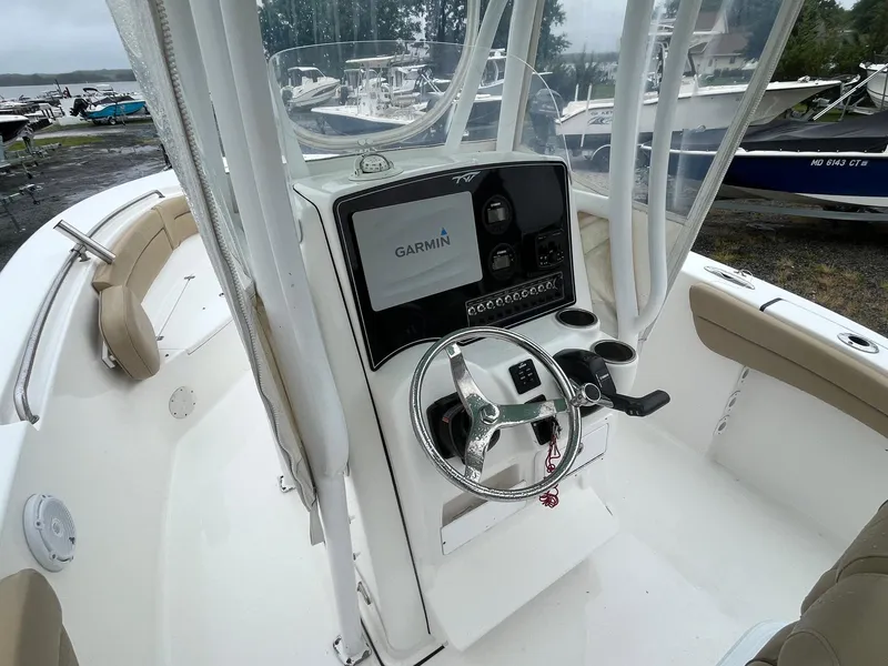 Slide: The Image of 2017 Tidewater 230 LXF boat cockpit with Garmin navigation system and steering wheel. - 8