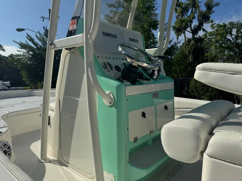 Slide: The Image of 2020 ShearWater 250 boat console with Simrad electronics and white seating. - 12