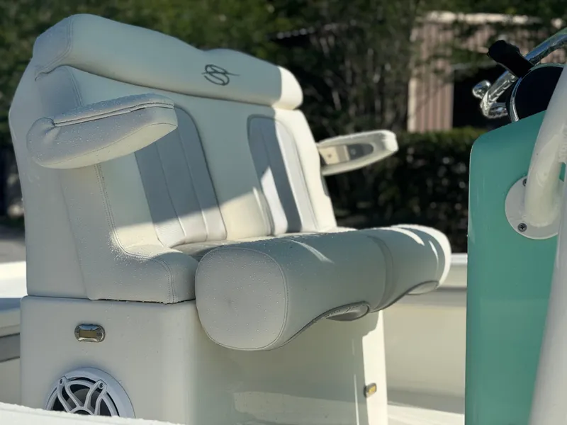 Slide: The Image of ShearWater 250 boat interior, 2020 model, featuring white cushioned seating and speaker. - 17