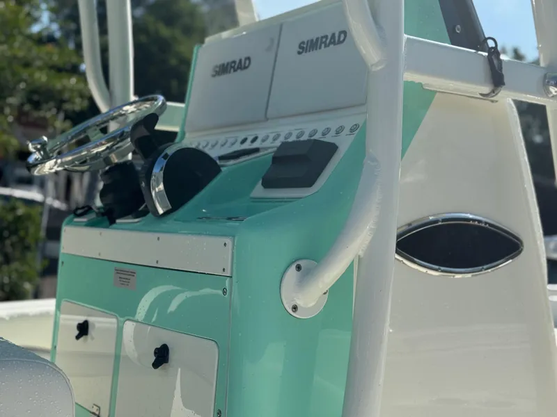 Slide: The Image of 2020 ShearWater 250 boat console with Simrad electronics and teal accents. - 18