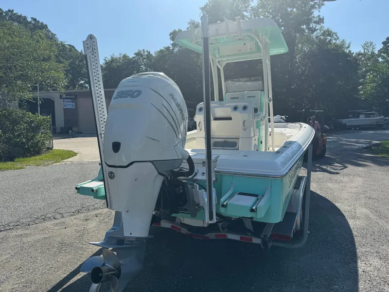 Slide: The Image of 2020 ShearWater 250 boat with powerful outboard motor, parked outdoors on a sunny day. - 6