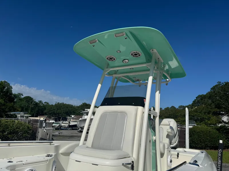 Slide: The Image of 2020 ShearWater 250 boat with green T-top under clear blue sky. - 8