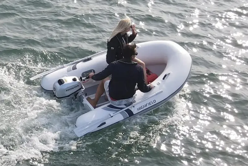 The Image of 2025 Highfield Ultralite 240SS inflatable boat on water with two passengers. - 0