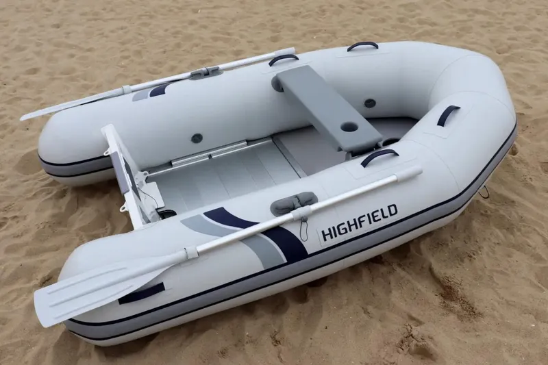 Slide: The Image of 2025 Highfield Roll-Up 280 KAL inflatable boat on sandy beach. - 3