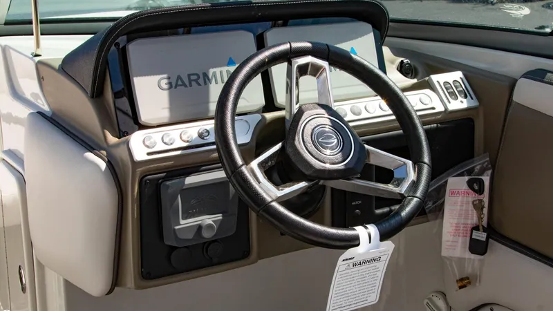 Slide: The Image of 2023 Crownline 290 XSS boat dashboard with Garmin navigation and steering wheel. - 10