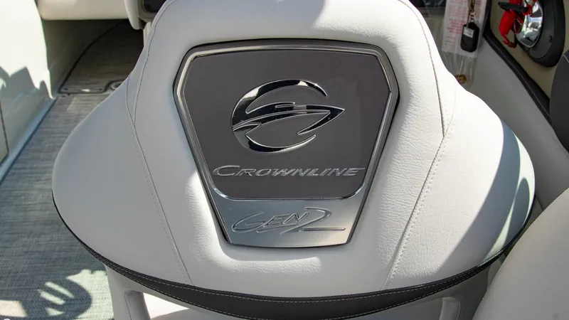 Slide: The Image of 2023 Crownline 290 XSS boat seat with logo and emblem detail. - 12