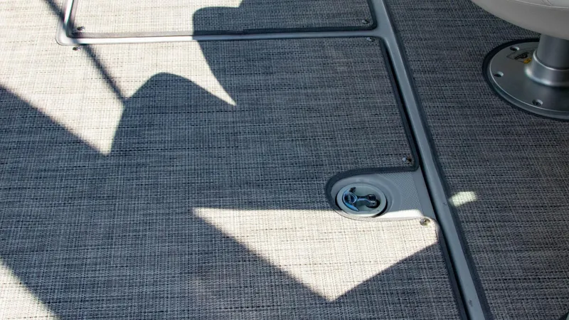 Slide: The Image of 2023 Crownline 290 XSS boat deck with textured flooring and metal fixtures. - 24