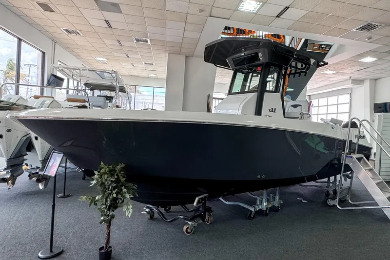 The Image of 2024 Wellcraft 263 Fisherman boat displayed in a showroom, featuring sleek design and modern amenities. - 0