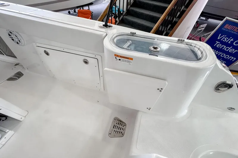 Slide: The Image of 2024 Wellcraft 263 Fisherman boat interior with storage compartments and livewell. - 10