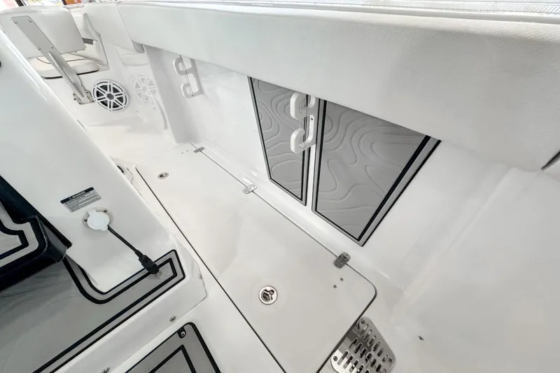Slide: The Image of 2024 Wellcraft 263 Fisherman interior, featuring sleek white seating and modern storage compartments. - 11