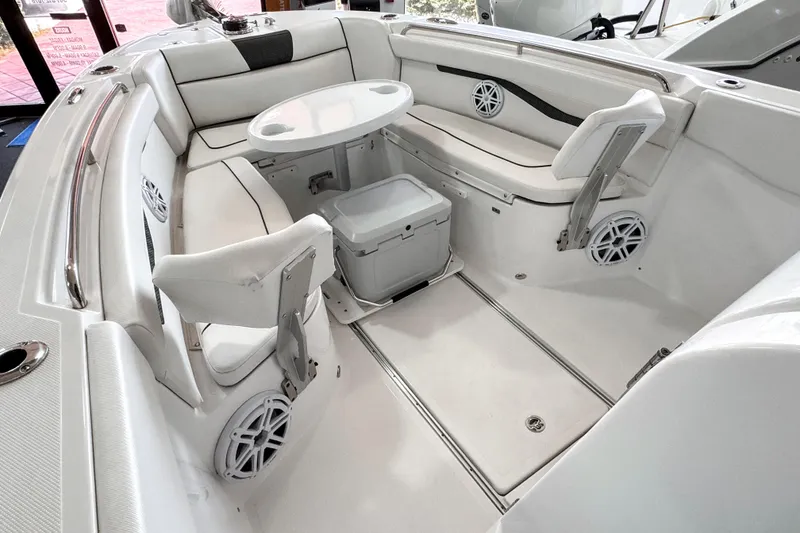 Slide: The Image of 2024 Wellcraft 263 Fisherman boat interior with seating, table, and speakers. - 14