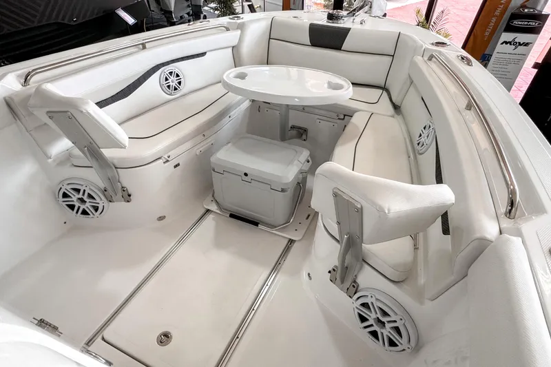 Slide: The Image of 2024 Wellcraft 263 Fisherman boat interior with white seating and round table. - 15