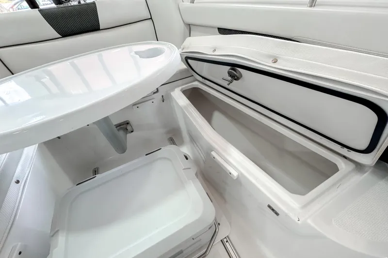 Slide: The Image of 2024 Wellcraft 263 Fisherman boat interior with storage compartment and table. - 16