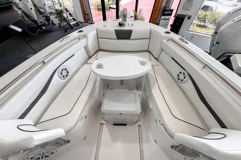 Slide: The Image of 2024 Wellcraft 263 Fisherman boat interior with white seating and round table. - 17