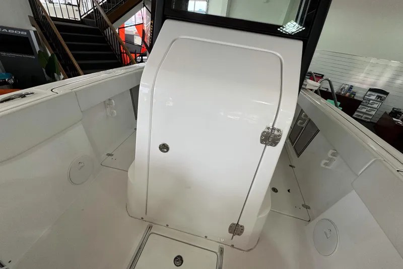 Slide: The Image of 2024 Wellcraft 263 Fisherman boat interior, featuring a white cabin door and sleek design elements. - 19