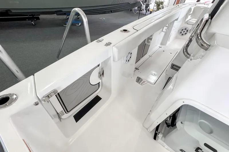 Slide: The Image of 2024 Wellcraft 263 Fisherman boat interior, featuring sleek white design and modern amenities. - 22