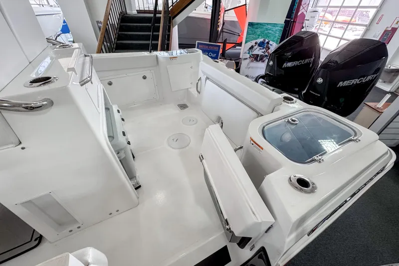Slide: The Image of 2024 Wellcraft 263 Fisherman boat interior with dual Mercury engines, spacious deck, and storage compartments. - 5
