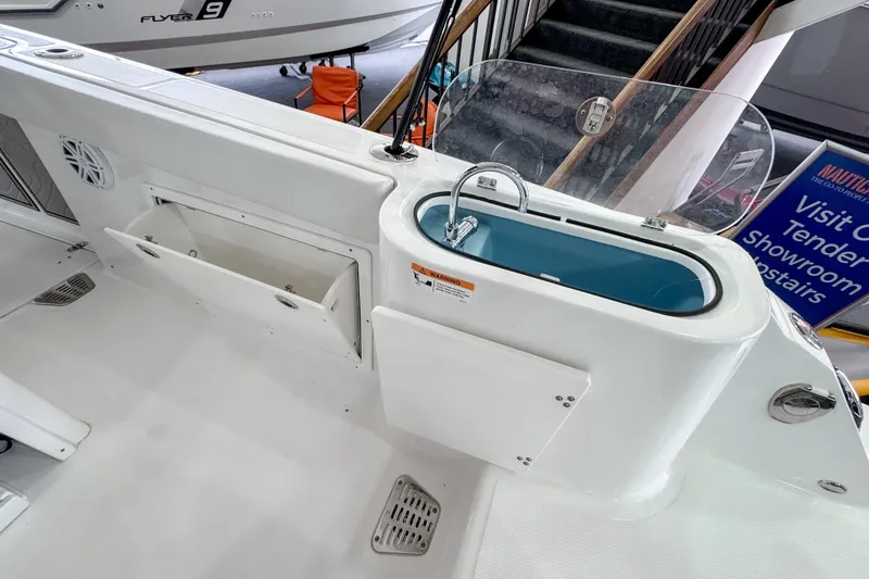 Slide: The Image of 2024 Wellcraft 263 Fisherman boat interior with livewell and storage compartments. - 9