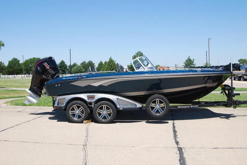 Slide: The Image of 2025 Ranger 620FS Cup Equipped boat on trailer, parked outdoors on a sunny day. - 0