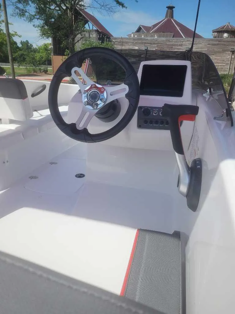 Slide: The Image of 2025 Tahoe T16 boat interior with steering wheel and control panel, showcasing modern design. - 3
