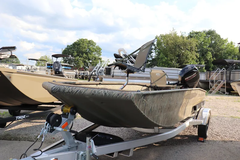 The Image of 2025 Tracker Grizzly 1650 T Prairie Wings Edition boat on trailer, outdoors. - 0