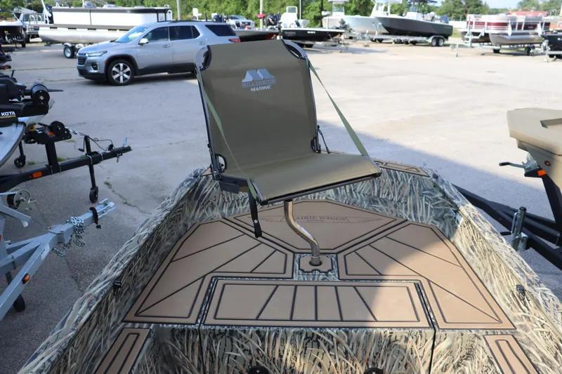 Slide: The Image of 2025 Tracker Grizzly 1650 T Prairie Wings Edition boat with camo design and mounted seat. - 2