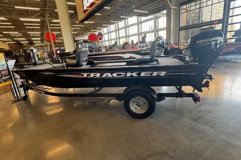 The Image of 2025 Tracker Panfish 17 boat displayed indoors with Mercury engine. - 0