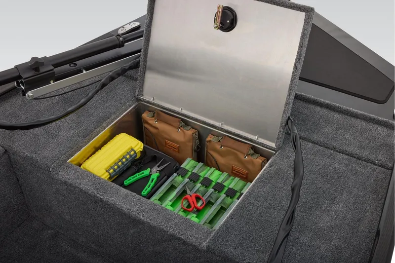 Slide: The Image of 2025 Tracker Panfish 17 boat storage compartment with fishing gear and tools. - 10
