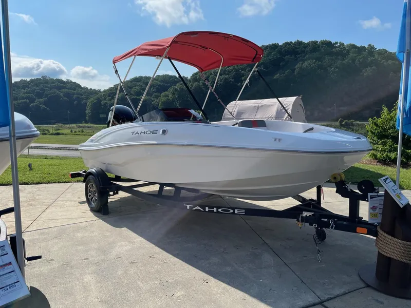 The Image of 2025 Tahoe T16 boat with red canopy on trailer, displayed outdoors. - 0