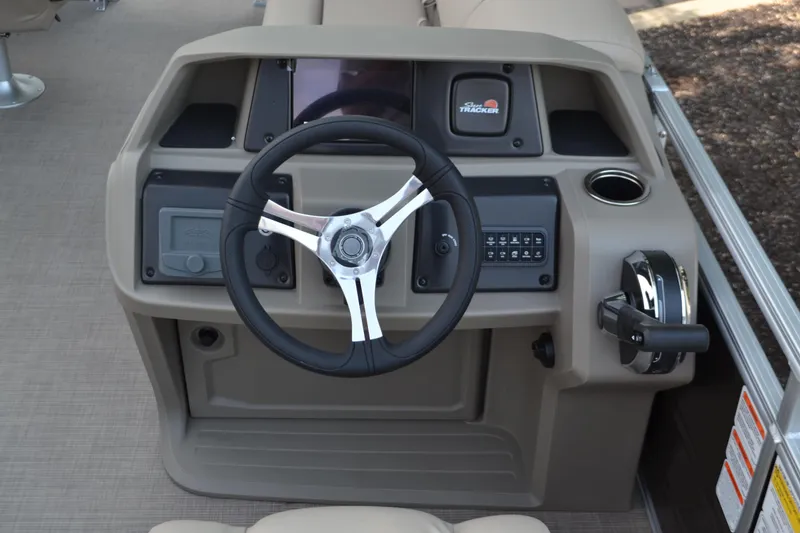Slide: The Image of 2025 Sun Tracker SportFish 20 DLX boat console with steering wheel and controls. - 3