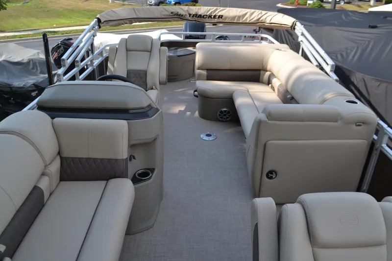 Slide: The Image of 2025 Sun Tracker SportFish 20 DLX pontoon boat with beige seating and spacious interior. - 5