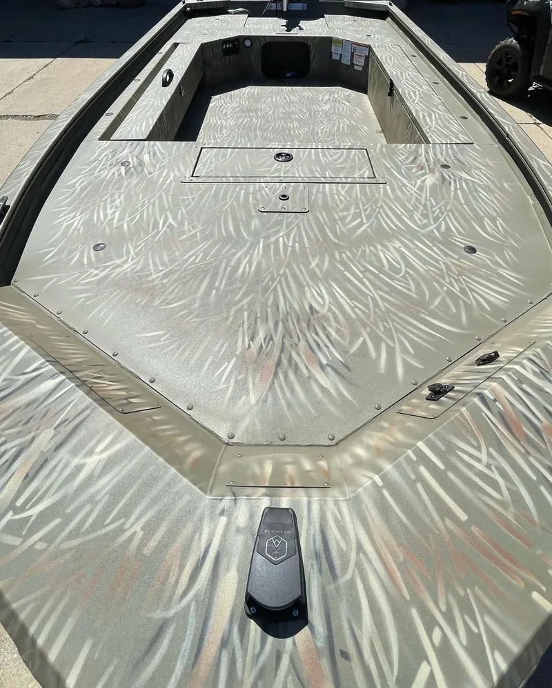 Slide: The Image of 2025 Tracker Grizzly 1654 T Sportsman boat with camouflage pattern on deck. - 2
