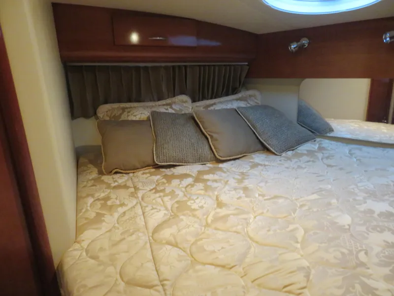 Slide: The Image of Luxurious bedroom interior of 2003 Carver 366 Motor Yacht with elegant bedding and cushions. - 21