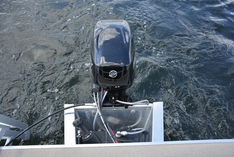 Slide: The Image of 2025 Starcraft LX 16 boat motor on water, rear view. - 9