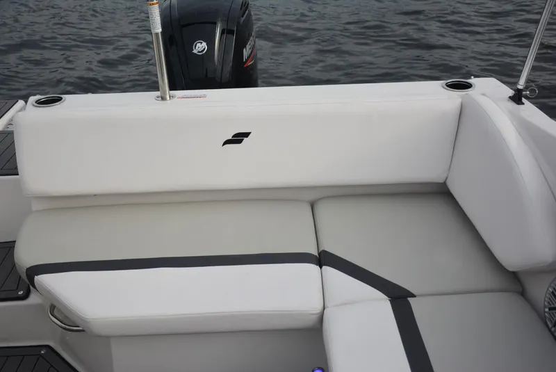 Slide: The Image of 2025 Starcraft SVX 171 boat interior with white cushioned seating and visible outboard motor. - 13