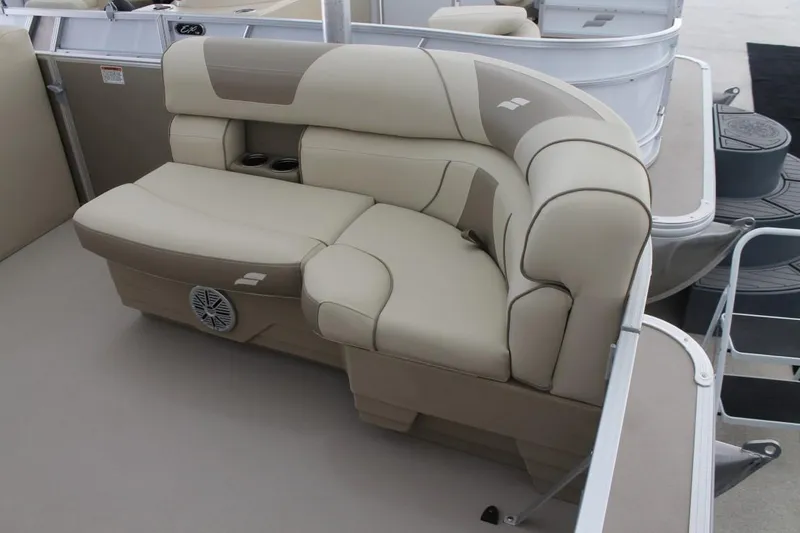 Slide: The Image of 2025 Starcraft EX 18 boat interior with beige cushioned seating and cup holders. - 11