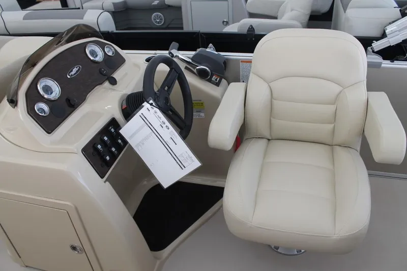 Slide: The Image of 2025 Starcraft EX 18 boat interior with steering console and beige captain's chair. - 15