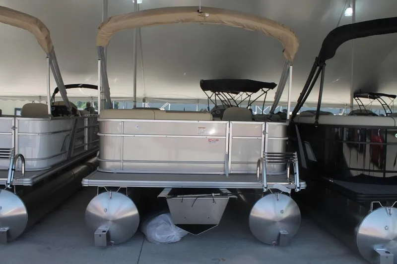 Slide: The Image of 2025 Starcraft EX 18 pontoon boat under a canopy display. - 4