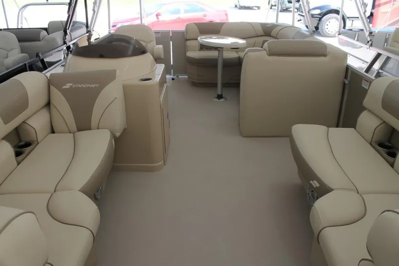 Slide: The Image of Interior of 2025 Starcraft EX 18 boat with beige seating and table. - 6