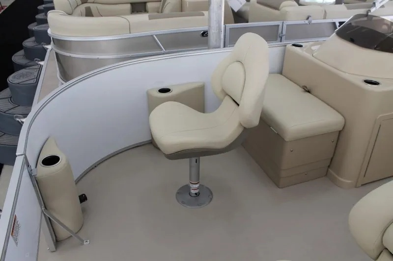 Slide: The Image of 2025 Starcraft EX 18 boat interior with beige seating and modern design. - 7