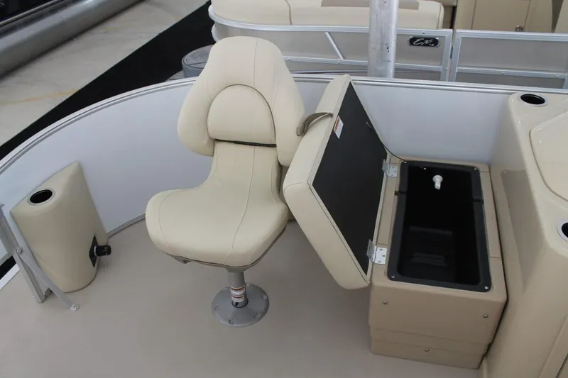 Slide: The Image of 2025 Starcraft EX 18 boat interior with beige seating and storage compartment. - 9
