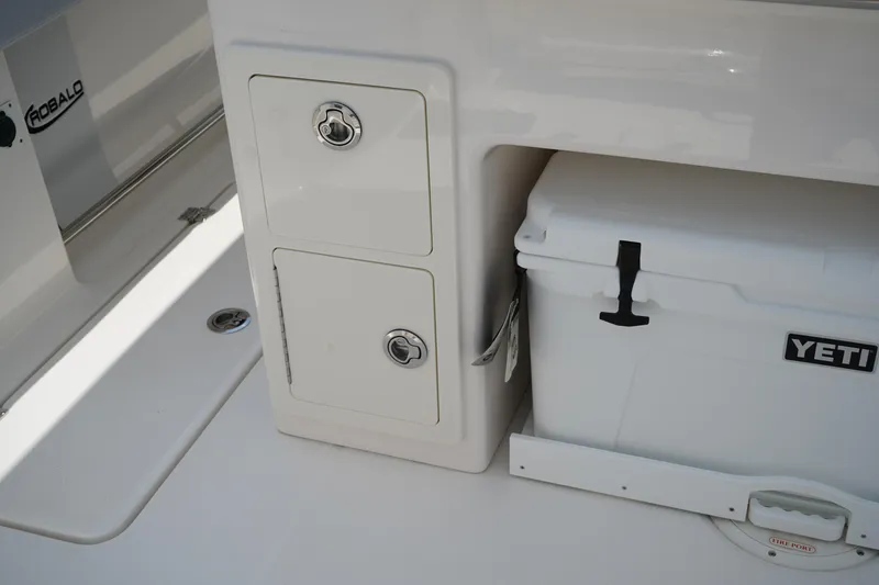 Slide: The Image of 2025 Robalo R300 Center Console with storage compartments and Yeti cooler. - 16
