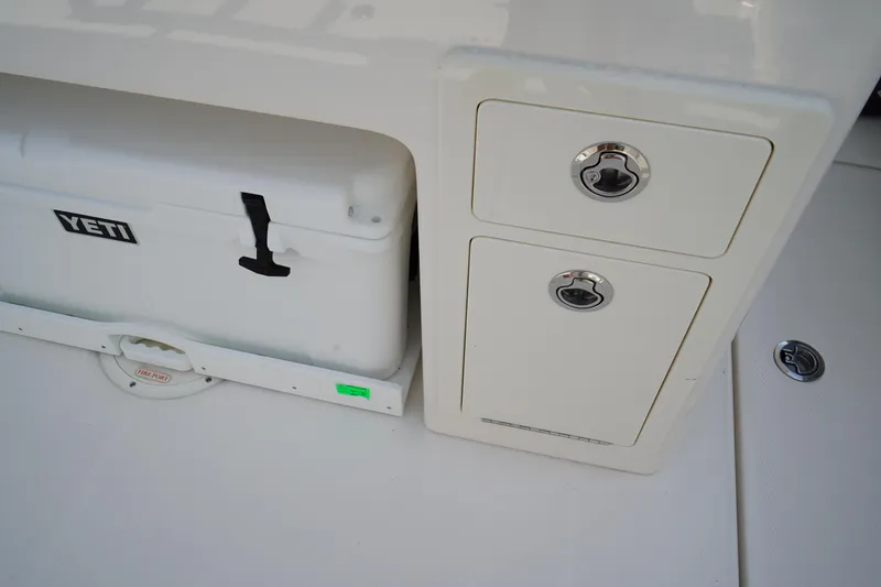 Slide: The Image of 2025 Robalo R300 Center Console with Yeti cooler and storage compartments. - 18