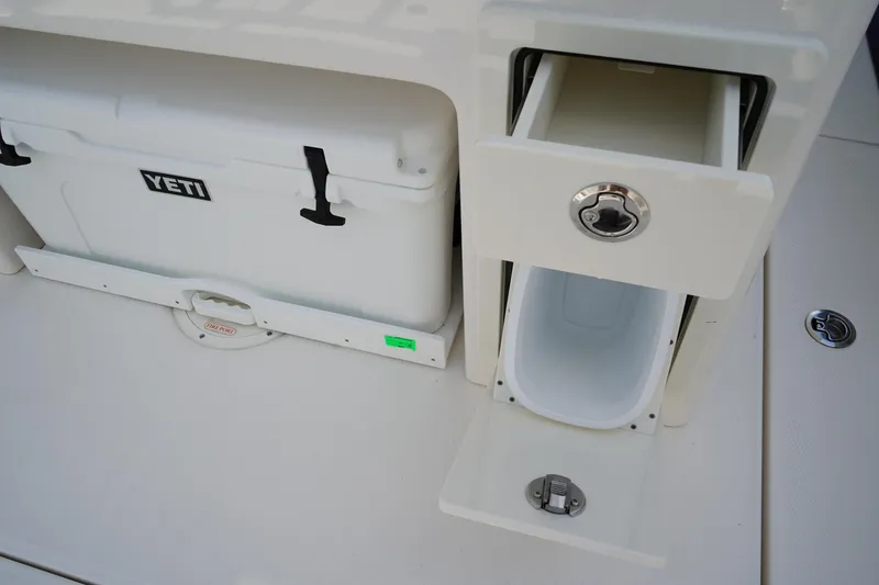 Slide: The Image of 2025 Robalo R300 Center Console with Yeti cooler and storage compartment. - 19